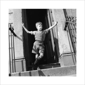 Boy standing in open doorway: 1957