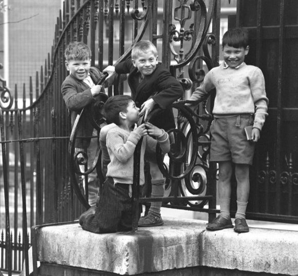 Four boys by railings. c.1955