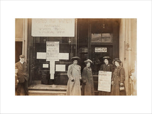 Photographic postcard of leading Suffragettes standing outside a branch shop of the Women's Social and Political Union in Hawick, Scotland.