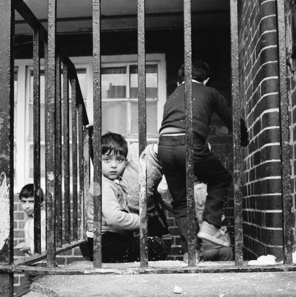 Children play outside their homes near Brick Lane: 1983