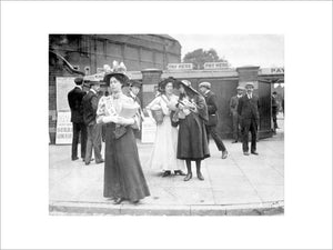 Suffragettes selling Votes for Women at Oval Cricket Ground entrance:1908