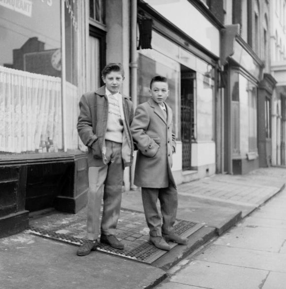 Two young 'teddy boys' pose in the street: 1960
