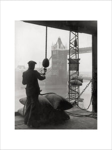 Pool of London Dockworker handling a cargo of bagged nuts 1947.