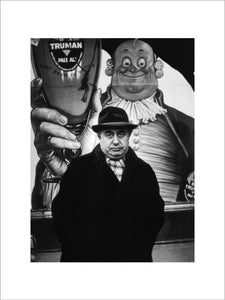 Man in front of a billboard advertising Truman Brewery: 1961