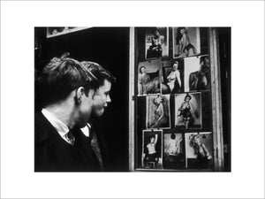 Two boys gazing at images of semi-nude women: 1961