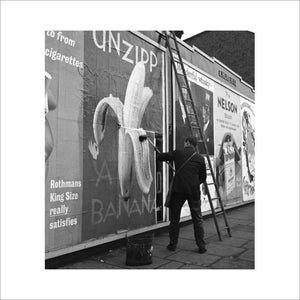 Man pastes up a billboard advertisement. c.1955
