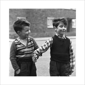 Two boys hold hands in street. c.1955