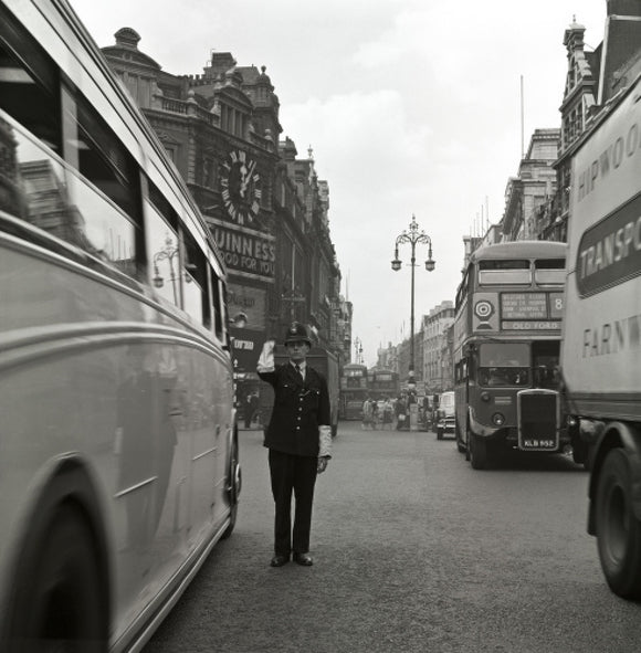 A policeman directing traffic, New Oxford Street. c.1955